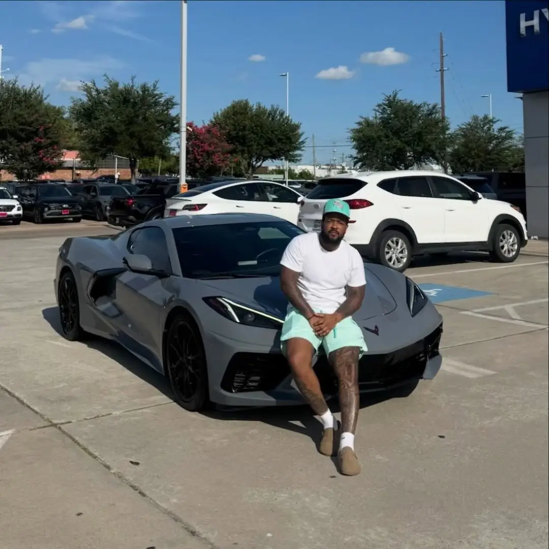 Customer beside a Corvette